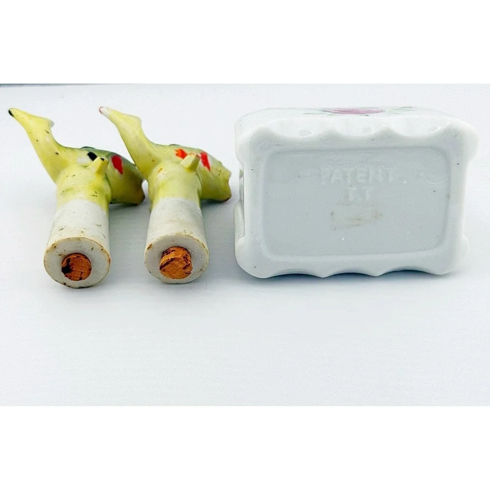 Vintage Japanese porcelain nodder fish salt & pepper shakers with a floral base